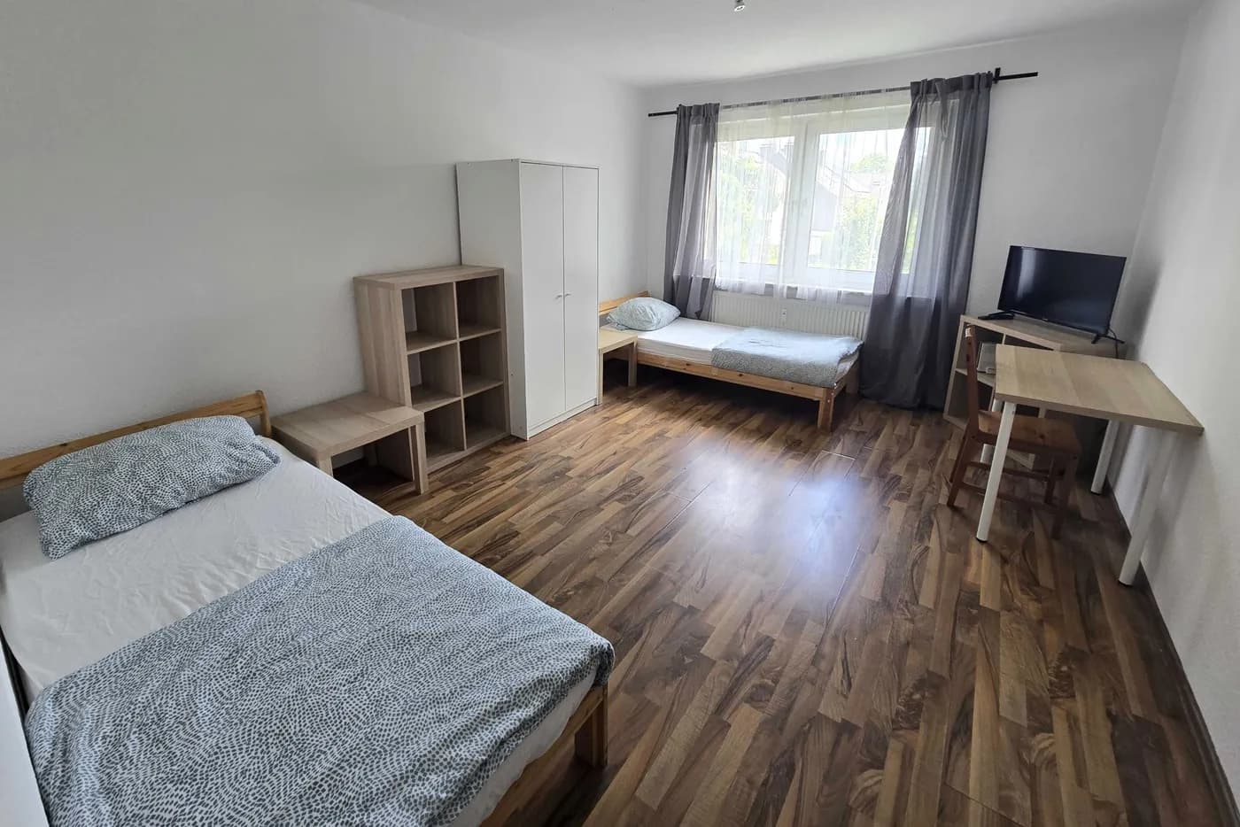 Helles Zimmer mit getrennten Einzelbetten in einem Monteurzimmer in Duisburg