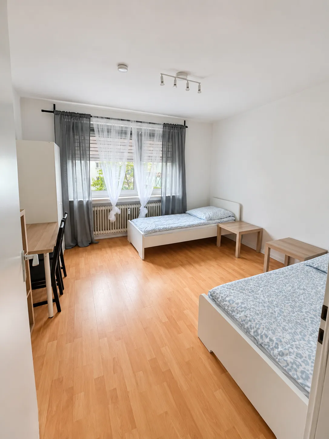 Weiteres Zimmer mit getrennten Einzelbetten in derselben Wohnung