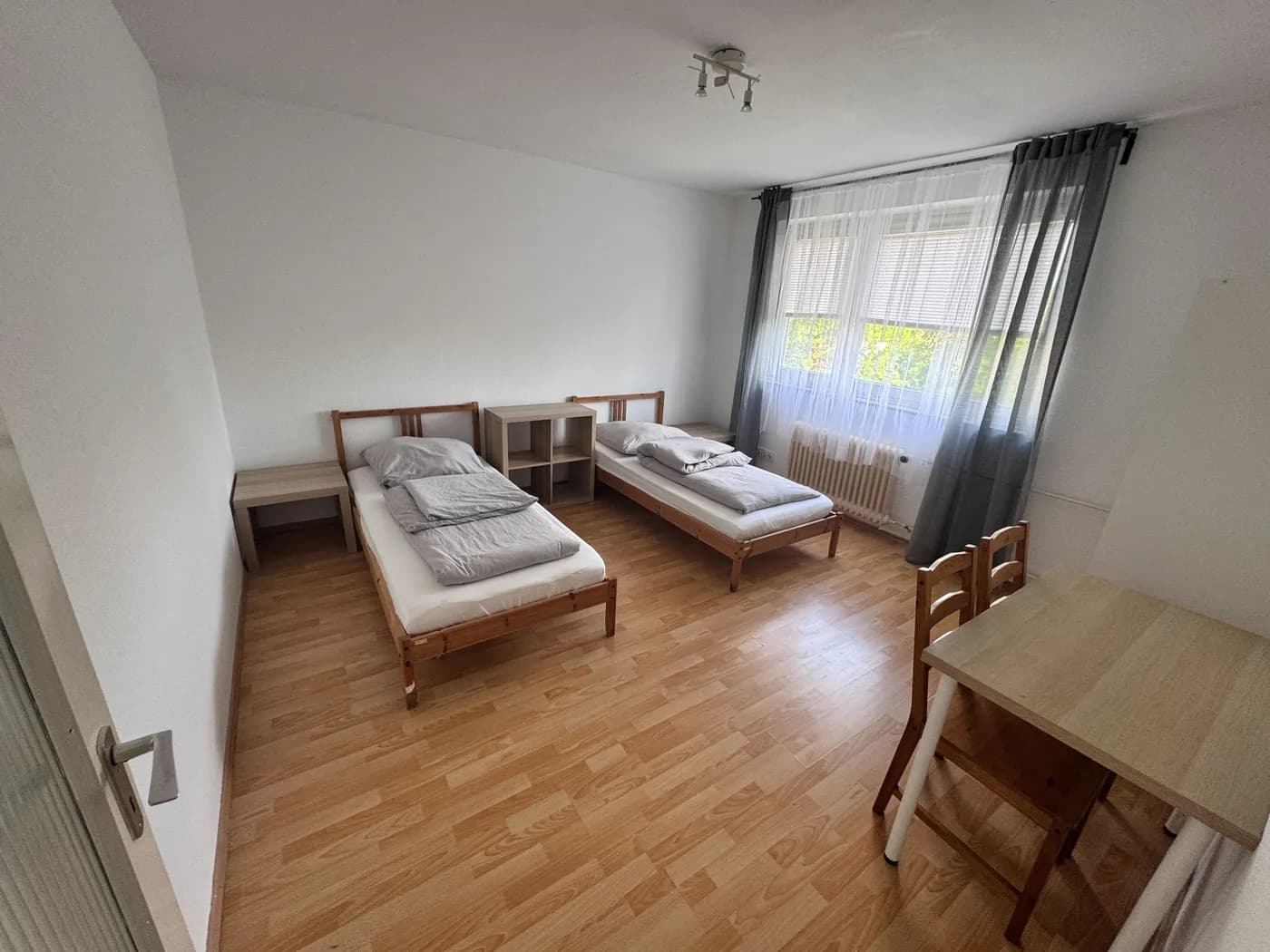 Helles Schlafzimmer einer Monteurwohnung in Solingen mit zwei getrennten Einzelbetten