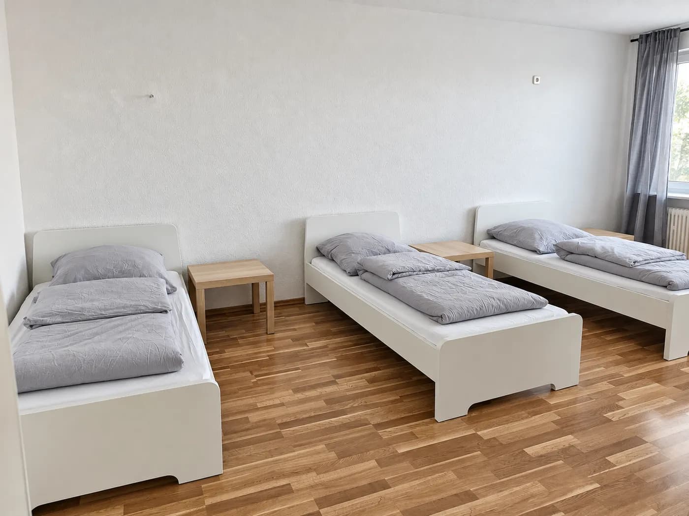 Schlafzimmer mit drei getrennten Einzelbetten in einer Hometime24 Wohnung in Wuppertal-Ronsdorf